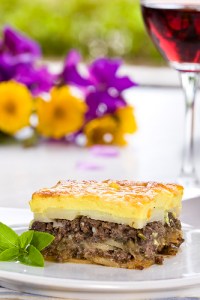 La Vista Lasange on plate with wine in glass and flowers